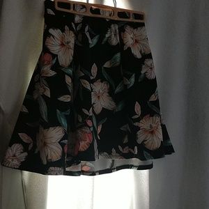 Black mini skirt with flowers.